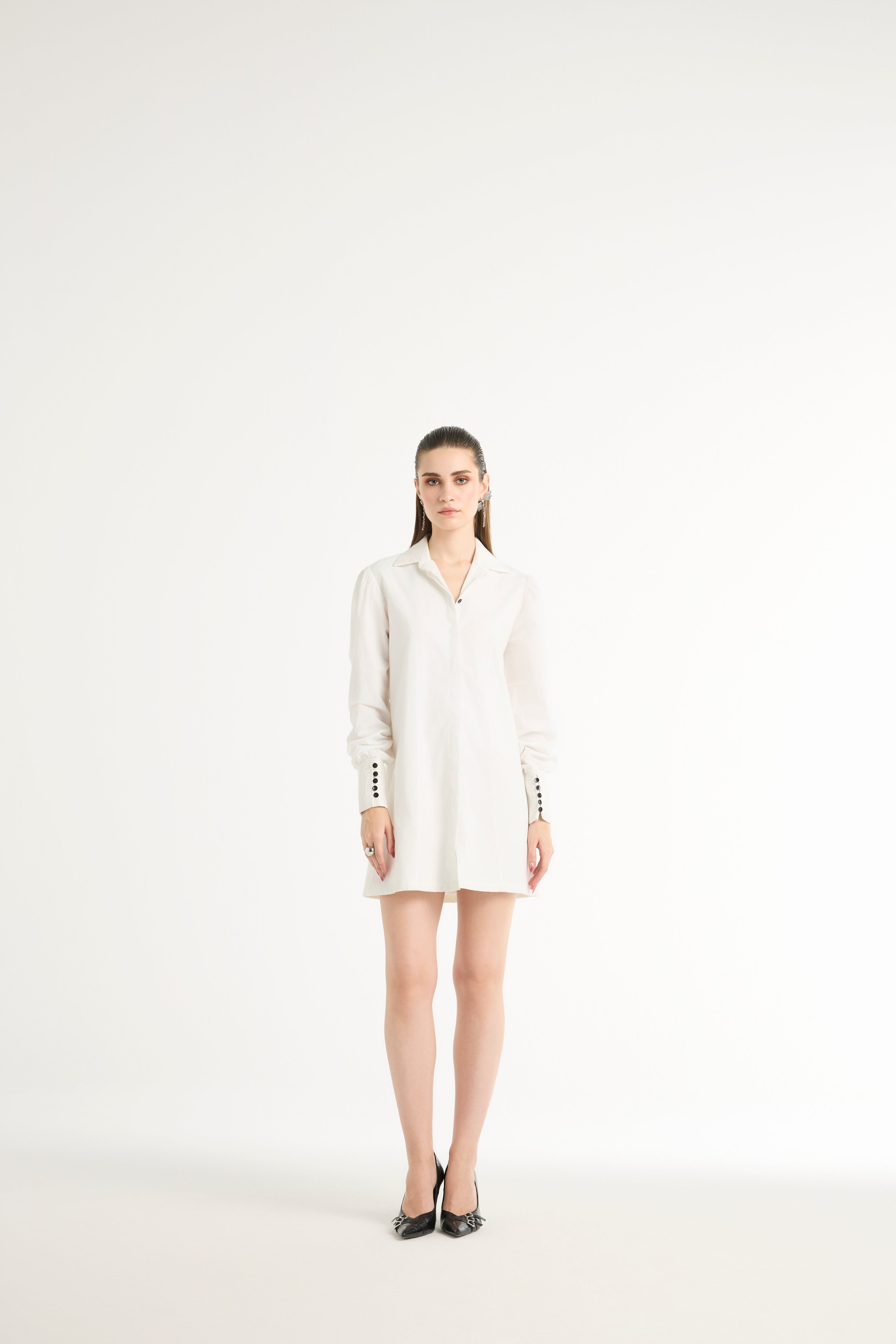 Woman wearing a white dress on a white background