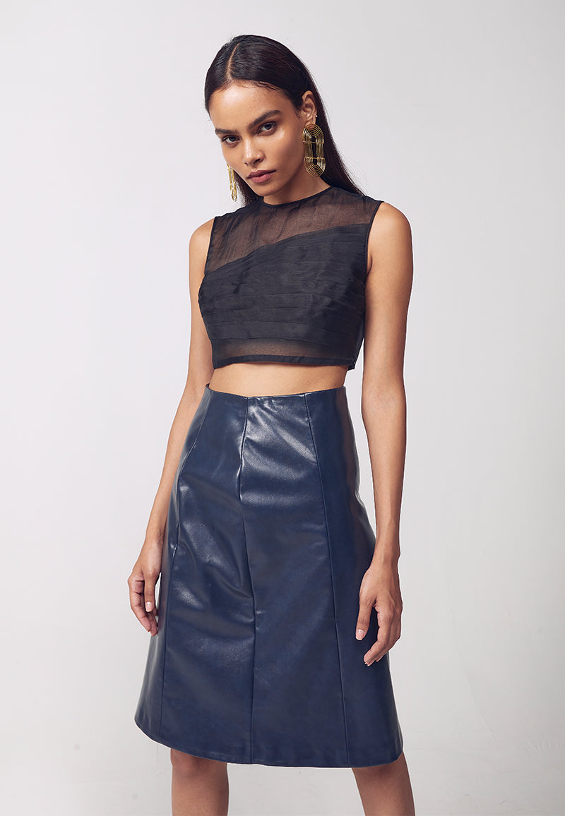 Best quality artificial leather midi skirt for women,which is favoured for its softness and clean glossy finish and echoing the designer's commitment to more ecological practices. This navy blue faux leather straight skirt features princess lines on both sides along with a concealed zip for closure. The skirt falls to the knee and is high-waisted. Pair yours with booties or thigh-high boots alone with a bodycon sweater or top with minimal gold jewelry to complete the look.