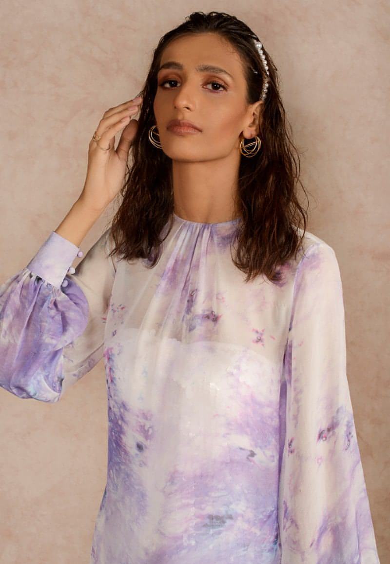 This purple and white sheer dye print midi dress with a sequin dress underneath can be styled in multiple ways. Made in chiffon and crepe this ensemble with handcrafted bandeau is perfect for the next date or formal evenings. Wear the piece in summer or style it in winter with an overlap jacket and stylish boots