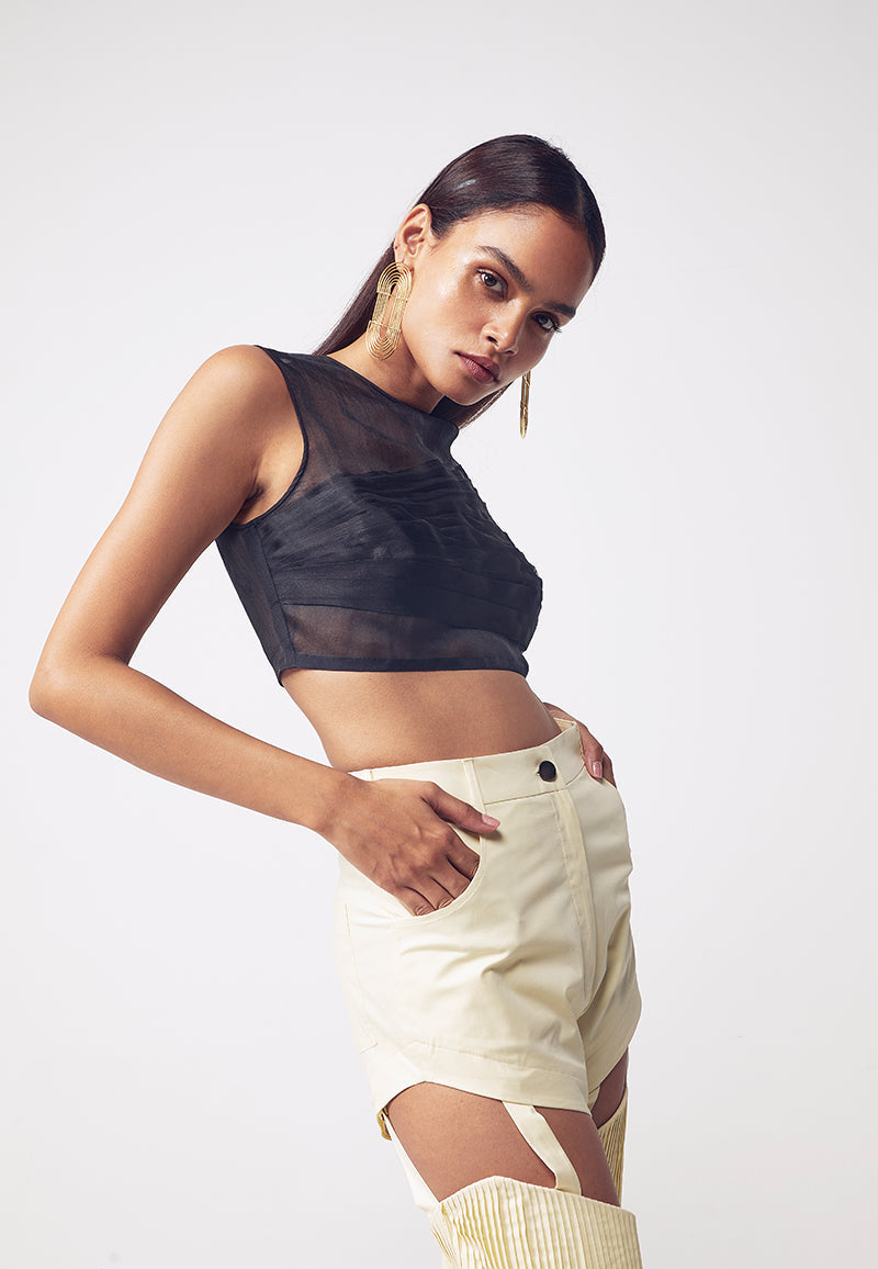 Style this black asymmetrical crop top in the spring, fall or summer. With its pleating detail, the organza semi-sheer sleeveless top brings the distinctive design to a refined new form. The top features an asymmetrical pleating detail with a concealed zip closure on the side and a button and loop closure on the neck. Wear it in multiple ways for versatile, minimal looks.