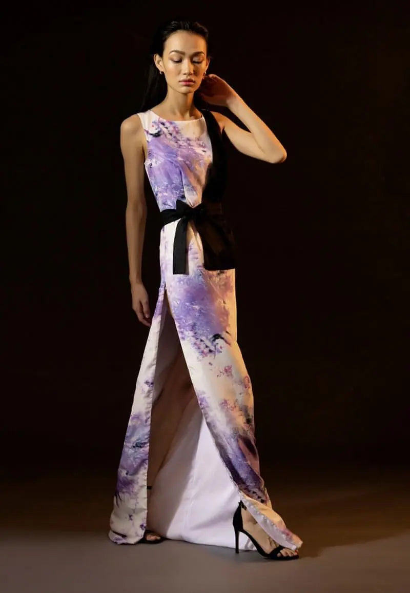 Mannat Guptas new half jacket style collection for women, this tie-dye straight maxi dress is crafted from silk and cotton. The black half-jacket style comes with a wrap around belt and a dramatic side slit which makes your look modern. The sleeveless maxi dress also features a high side slit for extra drama. Increase your confidence with this statement piece.