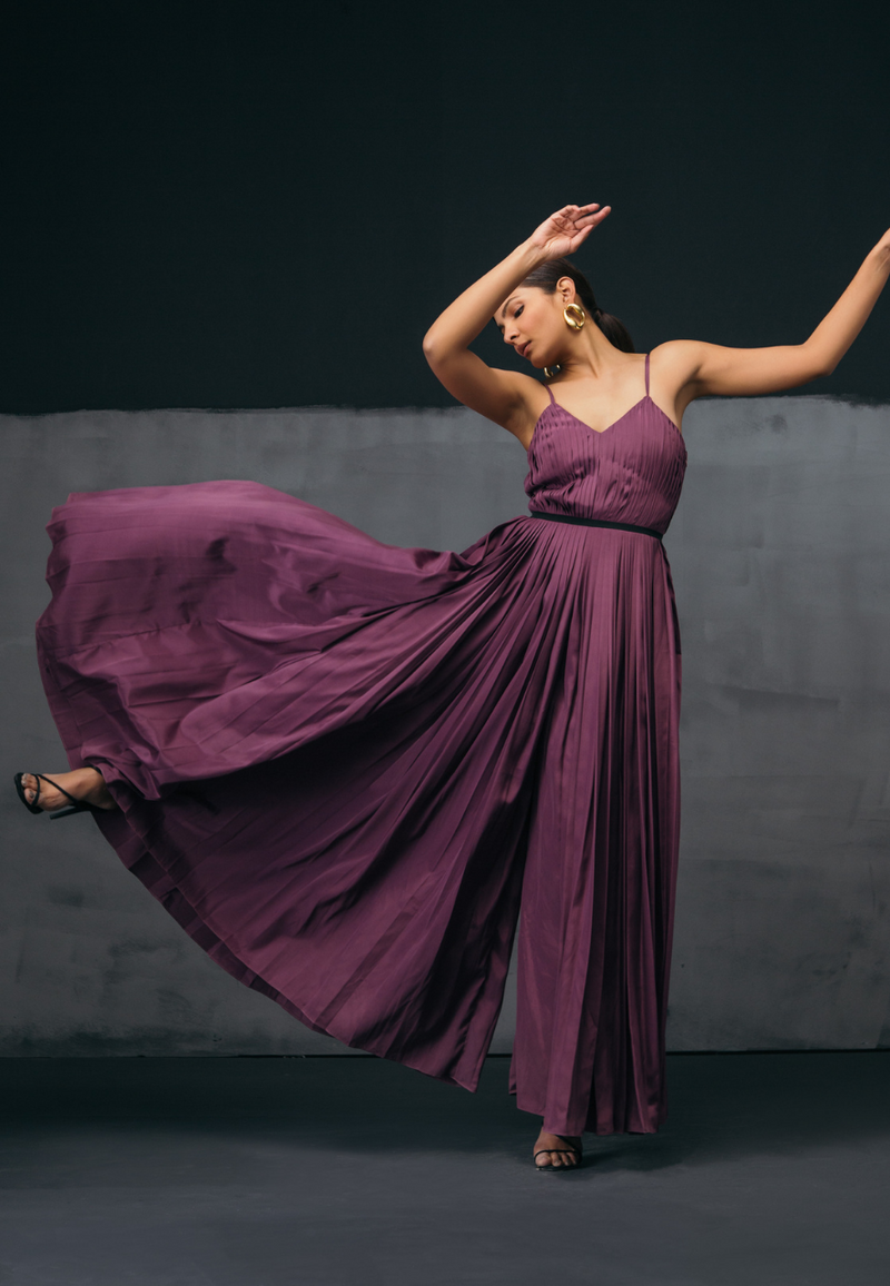Balance and proportion define Mannat Gupta's signature silhouettes, Ready for a party look with our jumpsuit and playsuit collection, This sleeveless purple jumpsuit comes with a special hand-pleating effect. Feel free to style this jumpsuit set with a black waistband which adds more definition to a woman's body. This piece is perfect for all seasons and layering. Pair the look with hoop earrings and heeled sandals for your next dinner date or a girl's night out. 